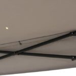 A close-up view of the underside of the 10.8 ft Pop-Up Gazebo Party Tent with Sheer Mesh Curtains, showing its beige canopy, sturdy metal frame, and a small light embedded in the fabric.